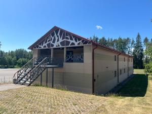 a large building with a staircase on the side of it at Alutaguse Tervisespordikeskuse Päikesemaja in Vasavere
