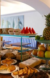 a buffet with plates of food on a table at Hotel Blaumar Cadaqués by Fimedhotels in Cadaqués