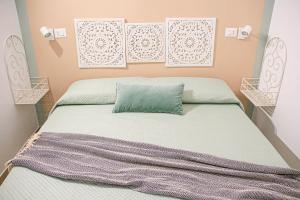 a bedroom with a bed with a green pillow at La Vispa Teresa Almalusa Apulian home in Martina Franca
