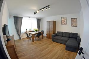 a living room with a couch and a table at Apartament Młyńska 26 in Augustów