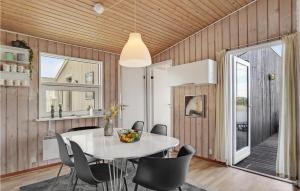 a dining room with a table and chairs at Holiday Home Baunebjergvej Sande V H in Havrvig