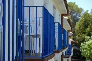 a blue balcony on the side of a building at Hotel Blaumar Cadaqués by Fimedhotels in Cadaqués