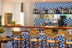 a bar in a restaurant with blue and white tiles at Hotel Blaumar Cadaqués by Fimedhotels in Cadaqués