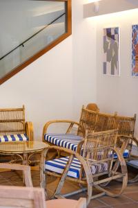 a group of chairs and tables in a room at Hotel Blaumar Cadaqués by Fimedhotels in Cadaqués