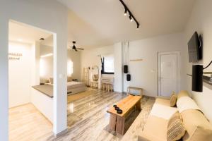 a living room with a couch and a table at Karystos Mare Apartments in Karistos