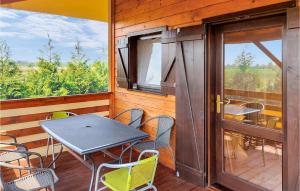 a patio with a table and chairs on a balcony at Lovely Home In Kladno With Kitchen in Pleśna