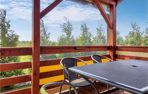 a table and chairs on the porch of a cabin at Lovely Home In Kladno With Kitchen in Pleśna