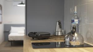 a kitchen counter with a blender and a bottle of water at FORUM EXPERIENCE Adults Only in Tarragona