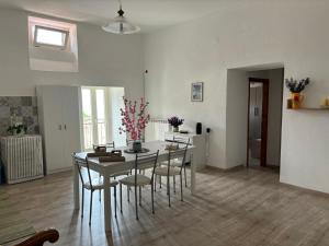 a dining room with a table and chairs at Al Castello Apartment in Fiumefreddo Bruzio