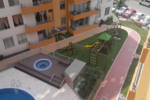 an aerial view of a playground in front of a building at 214 three bedroom apartment exclusive area cali in Cali