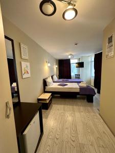 a hotel room with a bed and a desk at Lion's Hotel in Bucharest