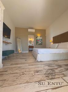 Postel nebo postele na pokoji v ubytování Su Entu Sardinian Country Club