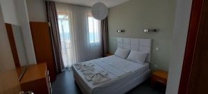a bedroom with a white bed in a room at Sozopol Paradise view in Sozopol