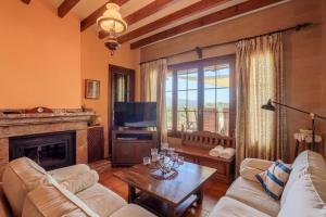 a living room with a couch and a fireplace at Can Pinoi by Rentallorca in Inca