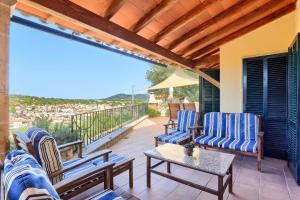 a patio with chairs and a table on a balcony at Can Pinoi by Rentallorca in Inca
