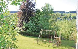 a swing in a yard with a garden at Holiday Home Schönberg With Table Tennis 194 in Schoenberg