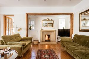 un salon avec un canapé et une cheminée dans l'établissement Beachside, Luxury Cottage, Devon, à Thurlestone