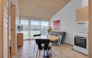 a kitchen with a table and chairs in a room at 2 Bedroom Lovely Home In Pandrup in Pandrup