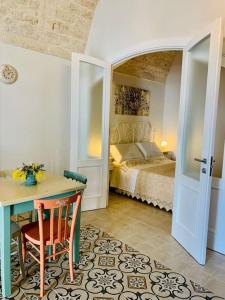 a bedroom with a bed and a table and a desk at Terry house in Noci