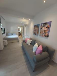 a living room with a couch and a bed at House Karga in Ormos Panagias