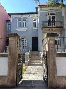 an entrance to a house with a gate and stairs at Casa D'Almeida by Porto Stories in Porto