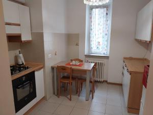 a small kitchen with a table and a stove at Al Giardino Che Non C'è in Trieste