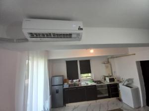 a kitchen with a white air conditioner on the ceiling at Twins Residence 2 APART HOTEL AP 2 2 rooms in Chiajna