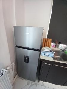 a stainless steel refrigerator in a kitchen with a sink at Twins Residence 2 APART HOTEL AP 2 2 rooms in Chiajna