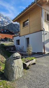 a large rock in front of a house at Studio Saint Antoine Les Houches in Les Houches