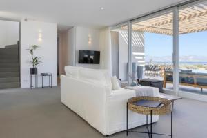 a living room with a white couch and a table at Big Blue Villas in Santa Maria