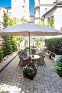a table and chairs under an umbrella on a patio at Shato Luxe in Odesa