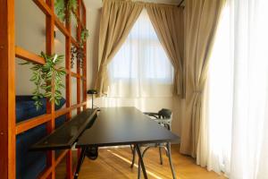 a dining room with a table in front of a window at Blue Arb Apartment Rab in Rab