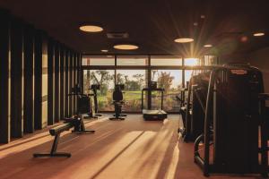 a gym with cardio equipment and a large window at Cape of Senses in Torri del Benaco