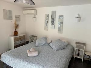 a bedroom with a large bed with blue sheets at Échappée Mistral - Jacuzzi Privé & Brasero in Eyragues +32 photos