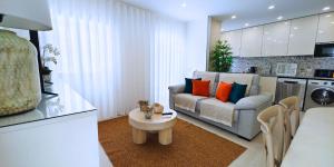 a living room with a couch and a table at Holidays Nazaré Centro in Nazaré