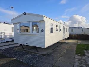 a tiny house is parked in a parking lot at Lyons Robinhood - 3 bedrooms in Rhyl
