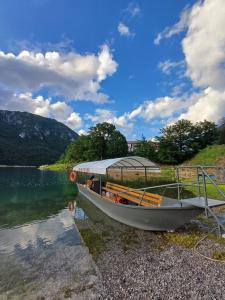 a boat parked on the shore of a lake at Apartment Relax in Plužine