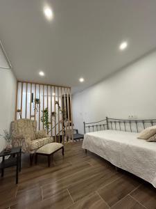 a bedroom with a bed and a couch and a chair at Carmen La Golondrina in Restábal