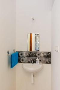 a bathroom with a sink and a mirror at Galaxy Homestays in Malpe +9 photos