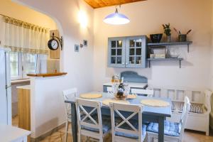 a kitchen and dining room with a blue table and chairs at Villa Maria in Koper
