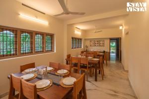 a dining room with wooden tables and chairs at StayVista at Spice Notes - Breakfast Included in Munnar