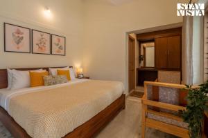 a bedroom with a large bed and a mirror at StayVista at Spice Notes - Breakfast Included in Munnar +19 photos