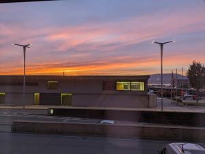 a building with two street lights in front of a sunset at Estudio al mar en el Casco Vello de Vigo in Vigo