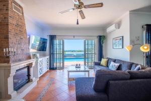 a living room with a couch and a fireplace at Charmante Villa mit 4 Schlafzimmer, Wlan und Zentralheizung in Santa Bárbara de Nexe