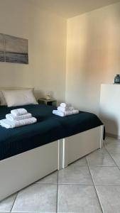 a bedroom with a bed with towels on it at Civico 59 Home apartments in Aragona