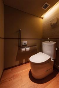 a bathroom with a white toilet in a room at Sora Niwa Terrace Kyoto Bettei in Kyoto