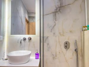a bathroom with a white sink and a shower at B Cozy Apartments in Limenaria +60 photos