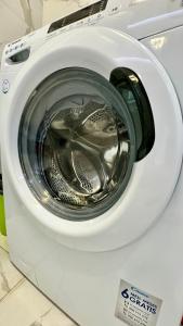 a front view of a washing machine with its door open at Heaven Apartment Drimades Olea Residence in Gjilek