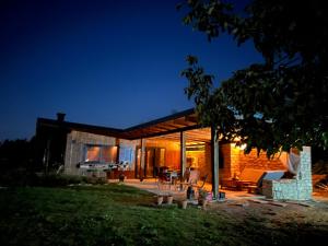 a contemporary house with a glass extension at night at Villa Les Terrasses in Ezerets