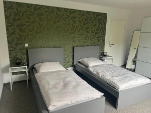 two beds sitting next to each other in a room at Erlebniseck in Simmelsdorf